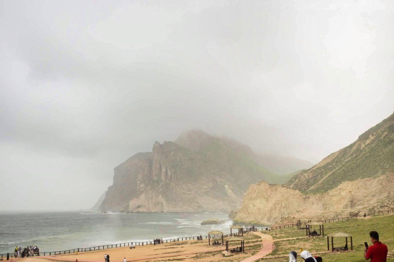 Salalah beach with a rocky cliff and a body of water