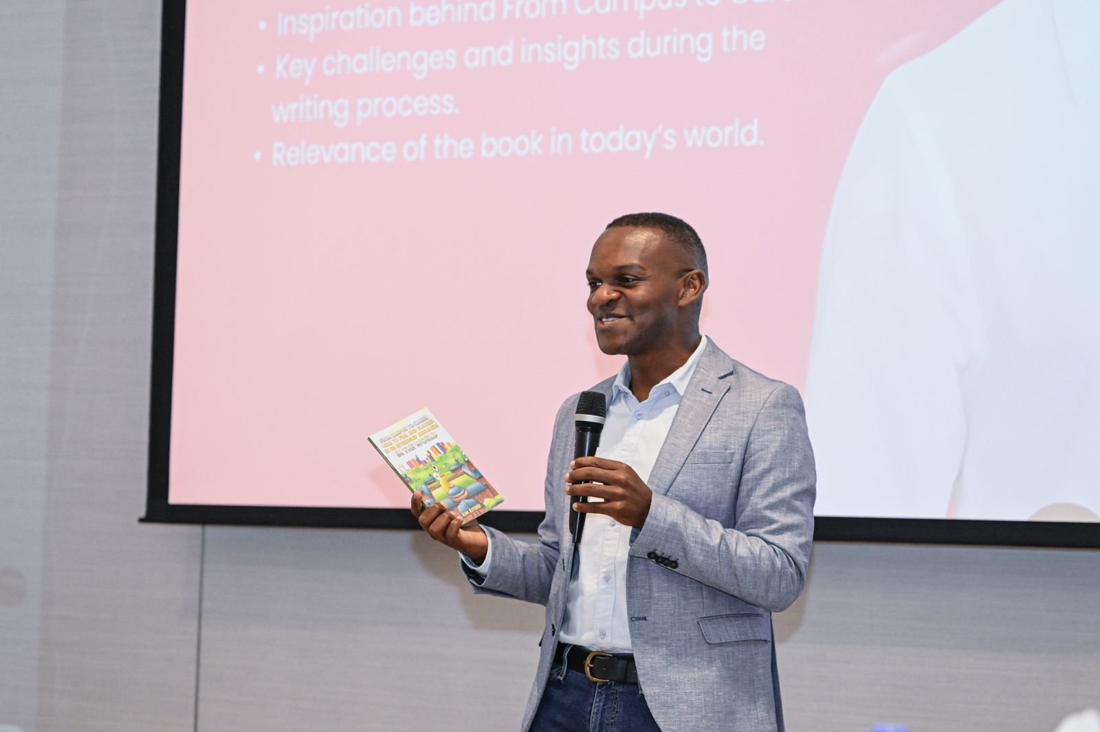 a man holding a microphone and holding a book