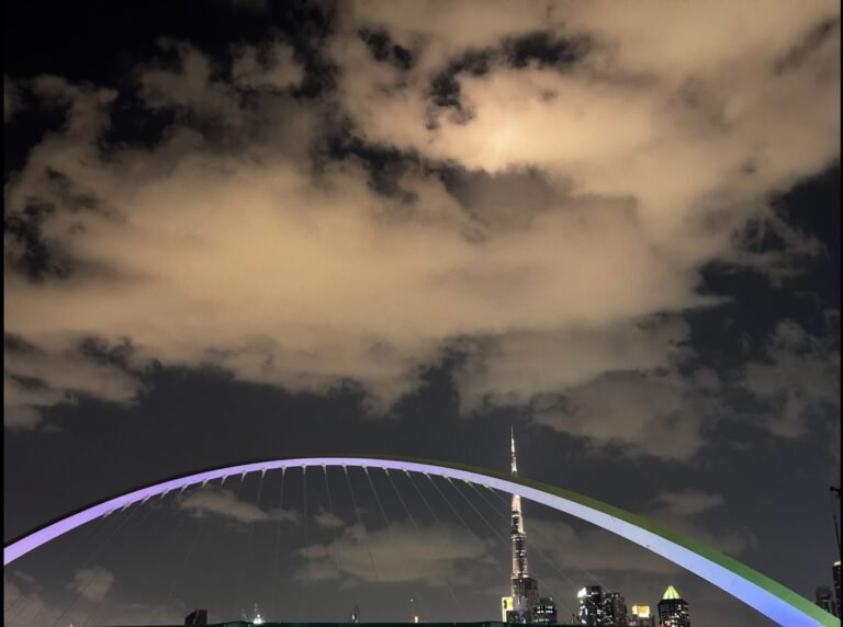 a bridge with a tall building in the background