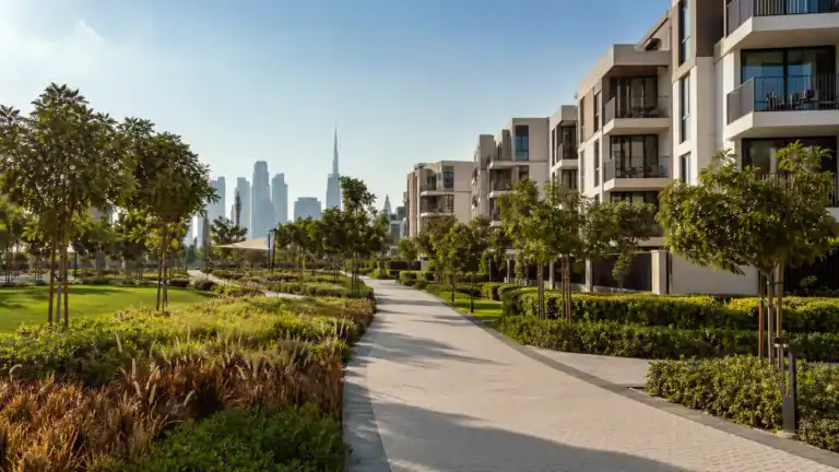 Dubai Hills Estate community walkway with park and apartments